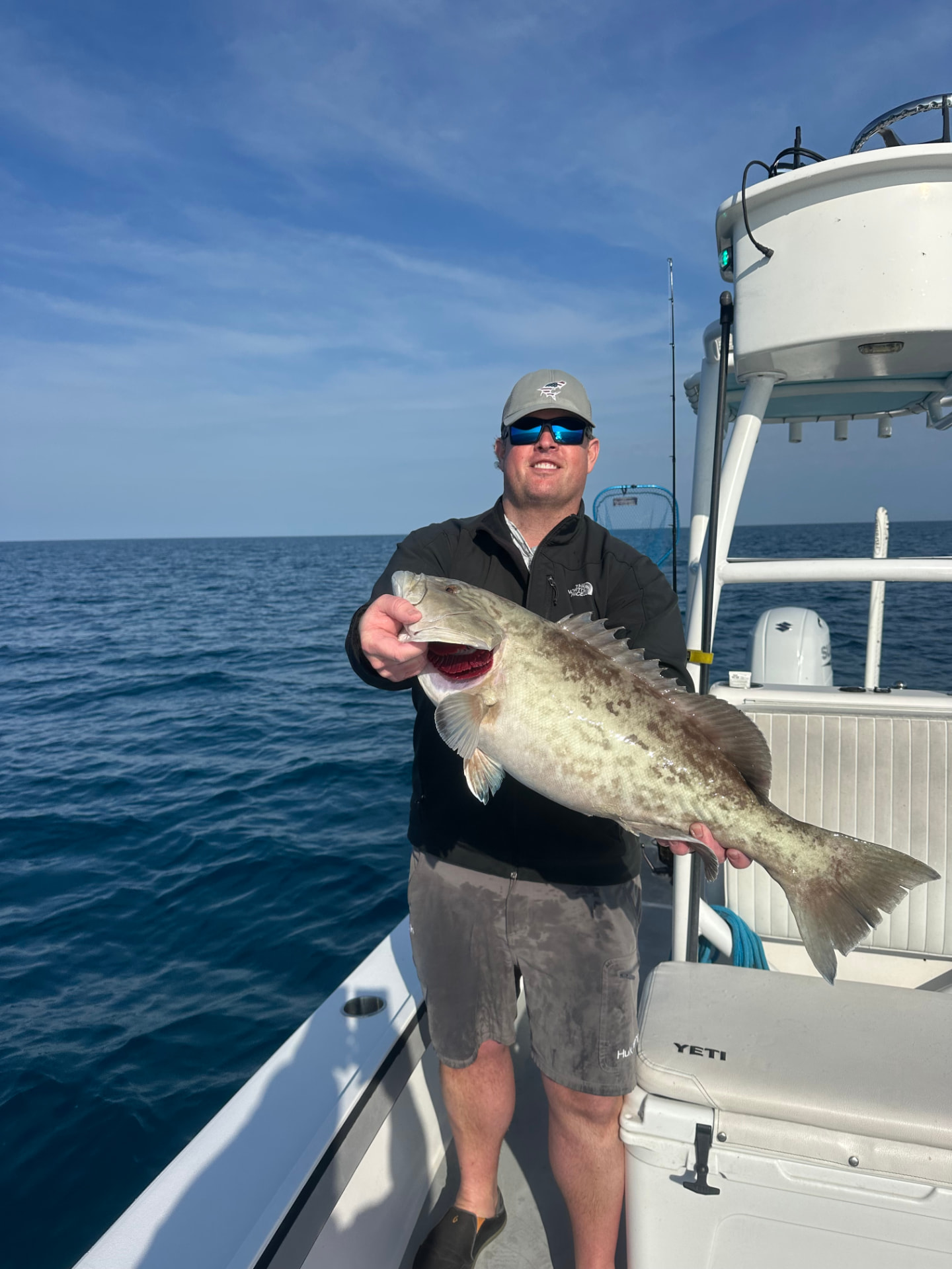 Angler with a large grouper caught offshore of Naples, Florida