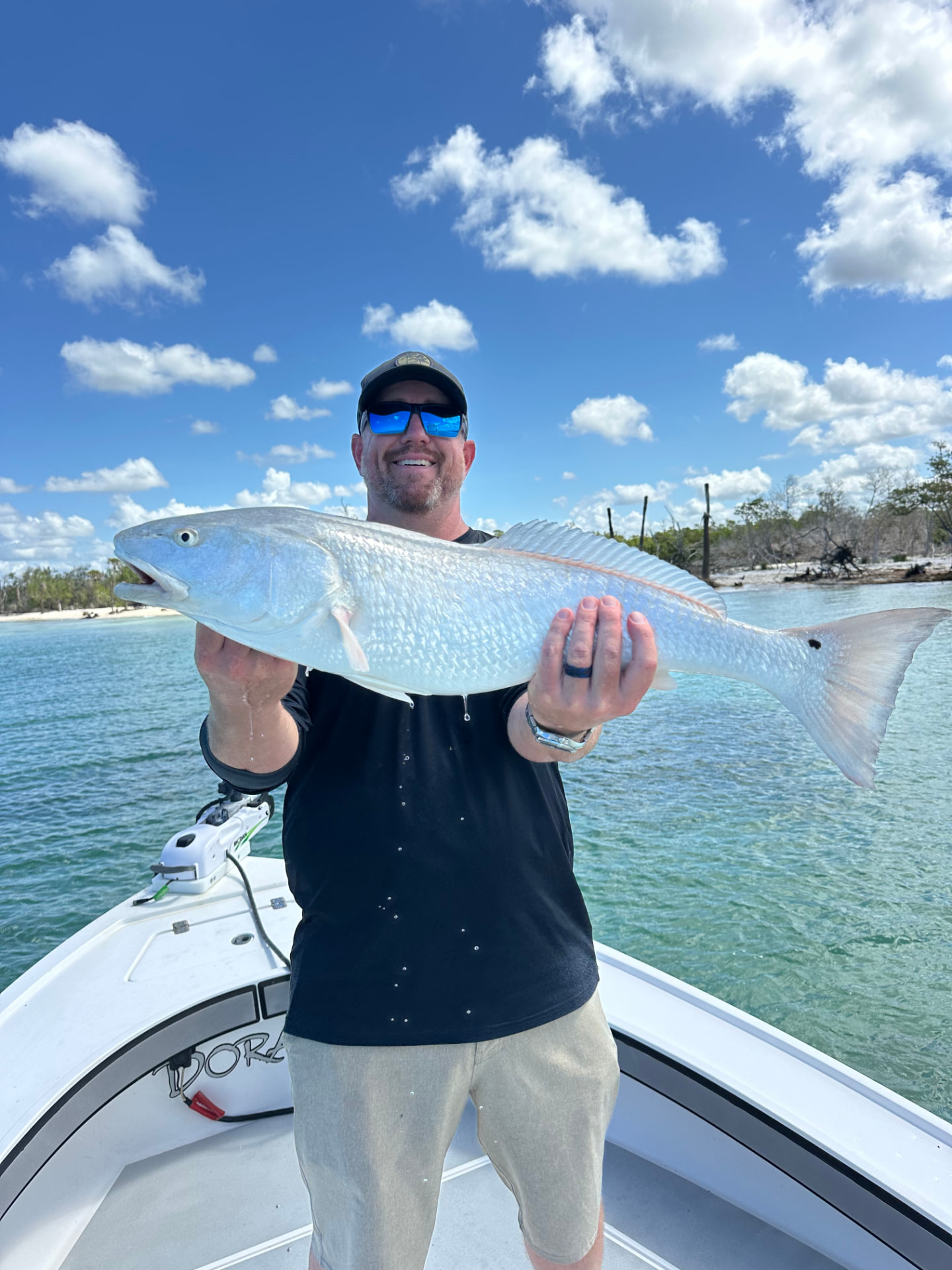 Angler with a bull redfish caught on a Naples backwater charter