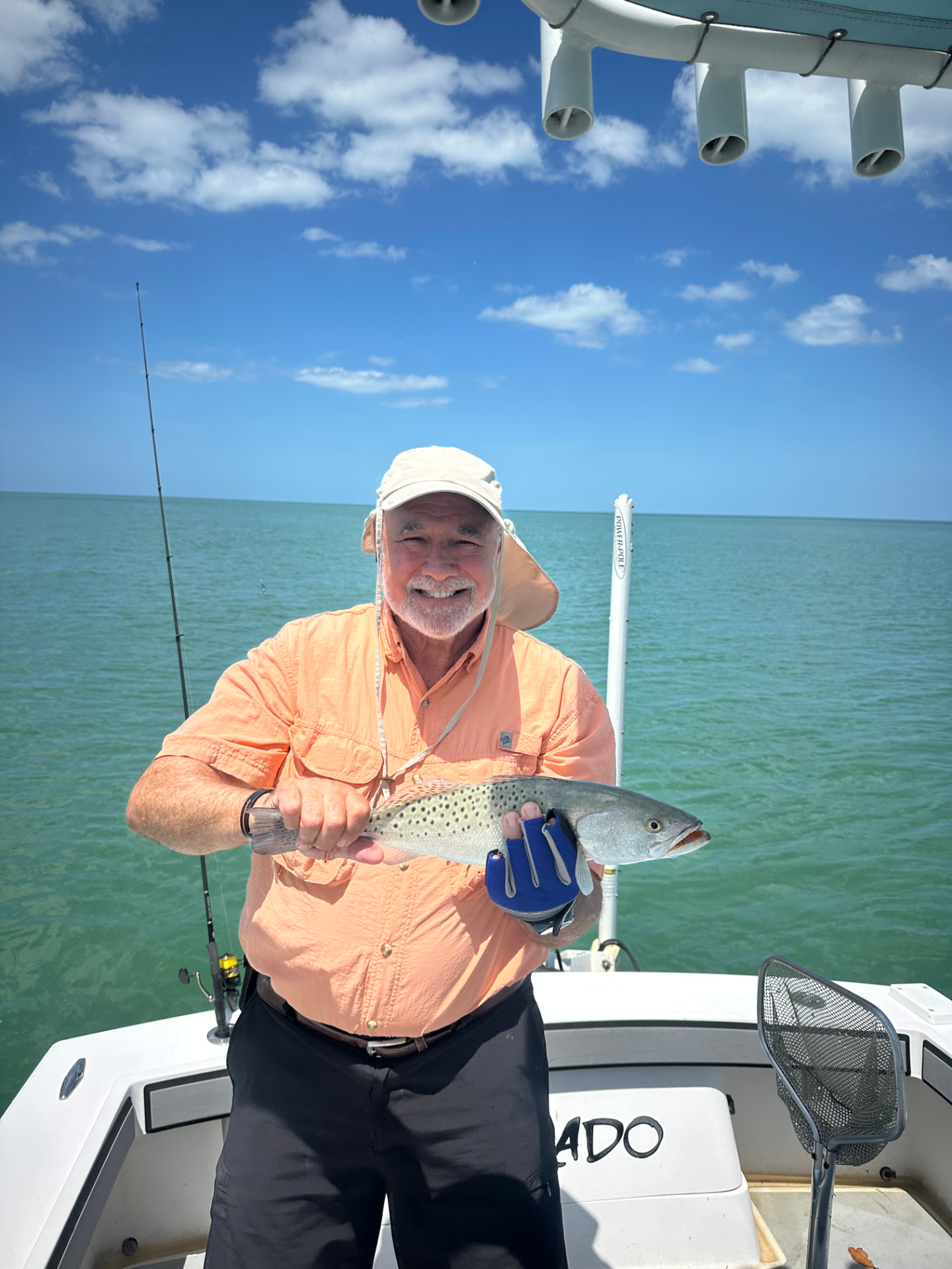 Angler holding a spotted sea trout caught on a Naples fishing charter