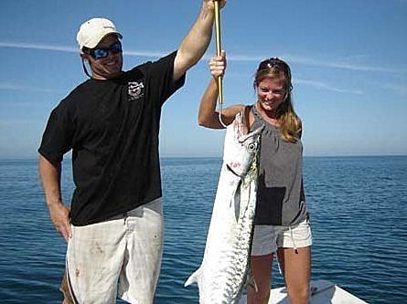 Anglers with a kingfish caught offshore of Naples, Florida